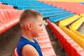 Child sits in sports stands