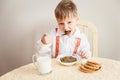 Five-year-old in a white shirt child eats lentils Royalty Free Stock Photo