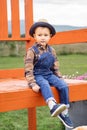 Child sitting on a big chair in a museum. Autumn