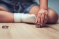 Child sitting with coins on the floor. Children are having fun sorting silver coins. Concept of finance and savings Royalty Free Stock Photo