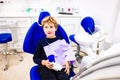 A child sitting in the dentist`s chair relaxed after his mouthwash Royalty Free Stock Photo