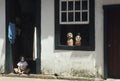 Child sitting at the door of his house in Tiradentes, Minas Gerais, Brazil.