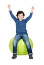 Child sitting on a pilates ball