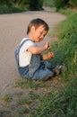 Child sitting by the roadside Royalty Free Stock Photo