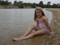 Child Sitting on a Sandbar.