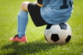 Child Sitting on Soccer Ball. Young Boy with Soccer Ball on the Pitch Royalty Free Stock Photo