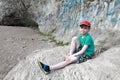 Child sitting on stone in grotto of Belaya River Valley Royalty Free Stock Photo