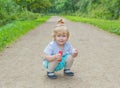 A child sitting on the street in the Park.