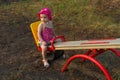 Child sitting on teeter-totter Royalty Free Stock Photo