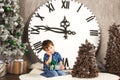 Child sitting under the Christmas tree with gifts Royalty Free Stock Photo
