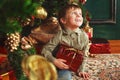 Child sitting under the Christmas tree with gifts Royalty Free Stock Photo