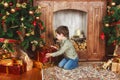 Child sitting under the Christmas tree with gifts Royalty Free Stock Photo