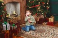 Child sitting under the Christmas tree with gifts Royalty Free Stock Photo