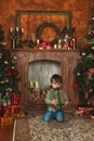 Child sitting under the Christmas tree with gifts Royalty Free Stock Photo