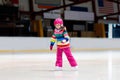 Child skating on indoor ice rink. Kids skate