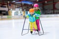 Child skating on indoor ice rink. Kids skate