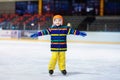 Child skating on indoor ice rink. Kids skate Royalty Free Stock Photo