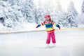 Child skating on outdoor ice rink. Kids skate Royalty Free Stock Photo