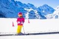 Child in ski school. Snow winter fun in mountains. Royalty Free Stock Photo