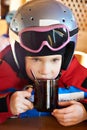 Child skier drinking tea Royalty Free Stock Photo