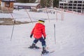 Child skiing in mountains. Active toddler kid with safety helmet, goggles and poles. Ski race for young children. Winter Royalty Free Stock Photo