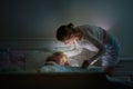 Child sleeping in dark bedroom. Little boy napping