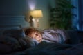 Child sleeping in dark bedroom. Little boy napping