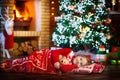 Child at Christmas tree. Kid at fireplace on Xmas Royalty Free Stock Photo