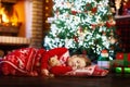 Child at Christmas tree. Kid at fireplace on Xmas Royalty Free Stock Photo