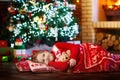 Child at Christmas tree. Kid at fireplace on Xmas Royalty Free Stock Photo