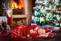 Child at Christmas tree. Kid at fireplace on Xmas Royalty Free Stock Photo