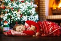 Child at Christmas tree. Kid at fireplace on Xmas Royalty Free Stock Photo