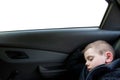 Child sleeping inside car wearing seat safety belt with copyspace in window Royalty Free Stock Photo