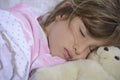 Child sleeping with teddy bear Royalty Free Stock Photo