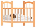 Child sleeps in bed in kids bedroom. African american baby lies in crib isolated on white Royalty Free Stock Photo