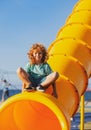 Child on slide playground area. Cute boy in the kids park having fun. Royalty Free Stock Photo