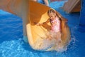 The child slides down the water slide with his eyes narrowed in fear Royalty Free Stock Photo