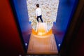 Child sliding down a slide, seen from the back from above Royalty Free Stock Photo