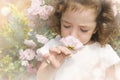 Child smelling flower on blurred hazy background