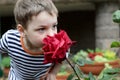 Child smelling rose