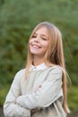 Child with smile on cute face outdoor. Little girl with long blond hair. Beauty kid with fresh look and skin. Beauty Royalty Free Stock Photo