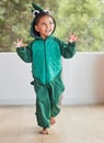 Child, smile and excited in halloween dinosaur costume at home playing role and having fun at party. Happy kid being