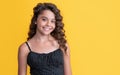 child smile with long brunette frizz hair on yellow background