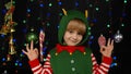 Blonde teen kid child girl in Christmas elf Santa Claus helper costume showingok gesture, okay sign Royalty Free Stock Photo