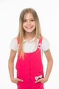 Child smiling with long blond hair. Small girl smile in pink jumpsuit isolated on white. Kid model in fashionable Royalty Free Stock Photo