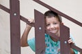 Child smiling through a railing Royalty Free Stock Photo