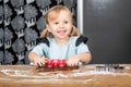 Child Smiling While Rolling Gingerbread Dough with Festive Baking Tool Royalty Free Stock Photo