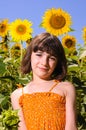 Child smiling in a sunflower field Royalty Free Stock Photo