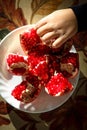 Child is snacking on a juicy ripe pomegranate