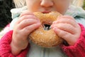 Child snacking on unhealthy chocolate donut